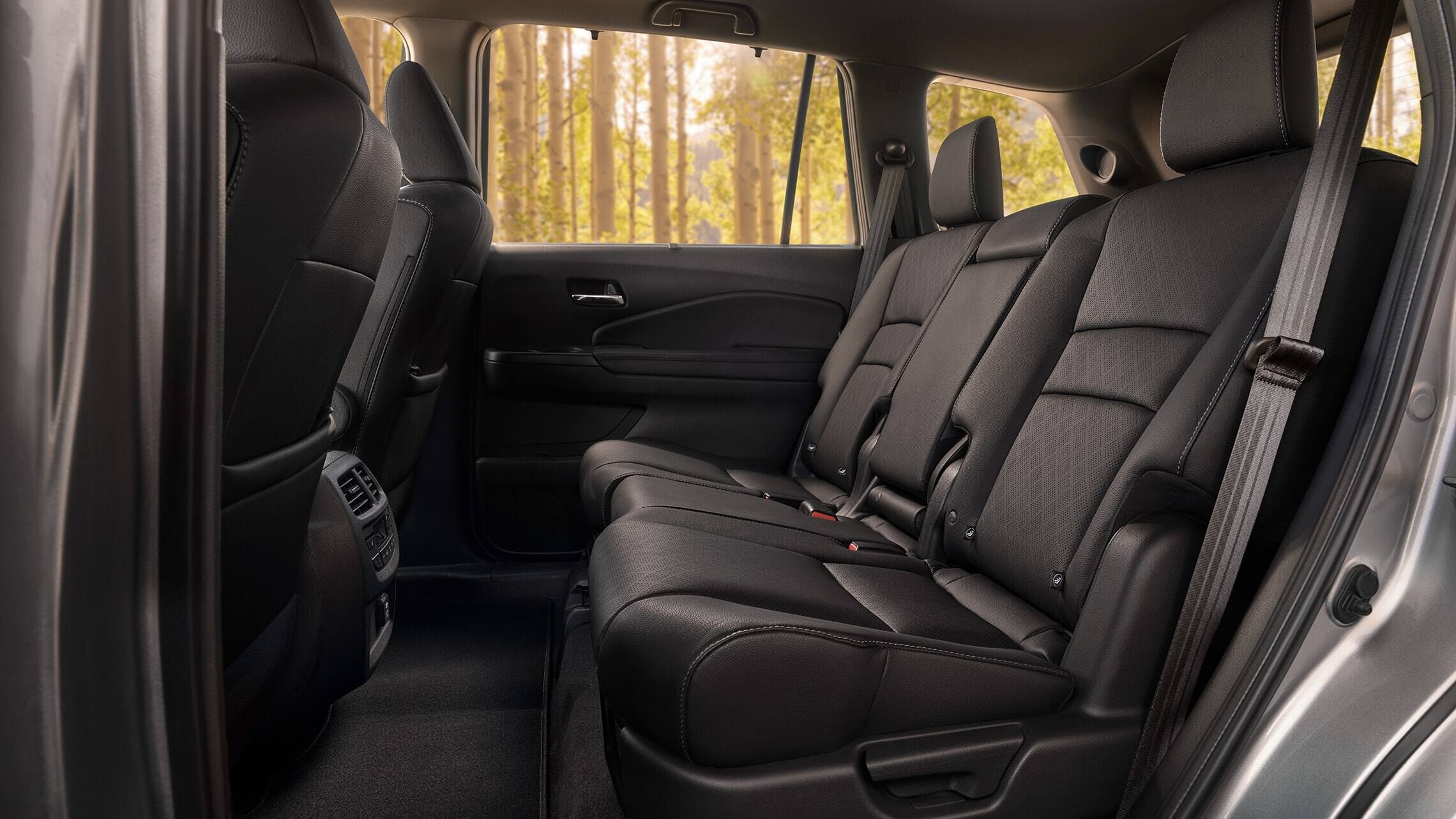 2019 Honda Passport Elite rear interior in Black Leather, displaying spacious 2nd-row seating.