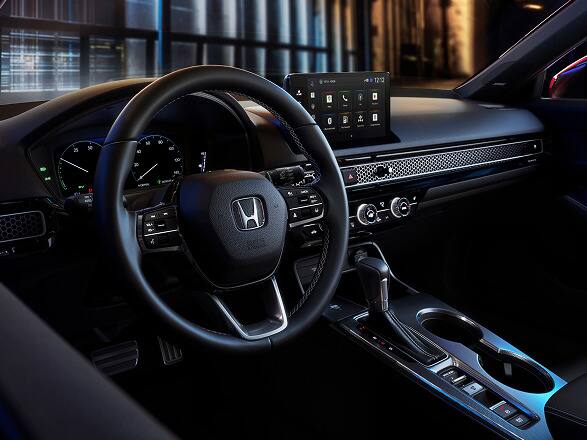 2027 Honda Civic Hatchback Sport Touring Hybrid interior dashboard, steering wheel, and digital infotainment screen (Compact Hatchback).